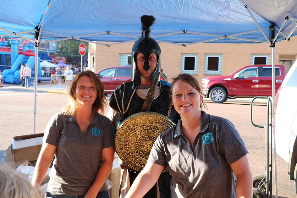 two DSU staff members standing with General Cy mascot